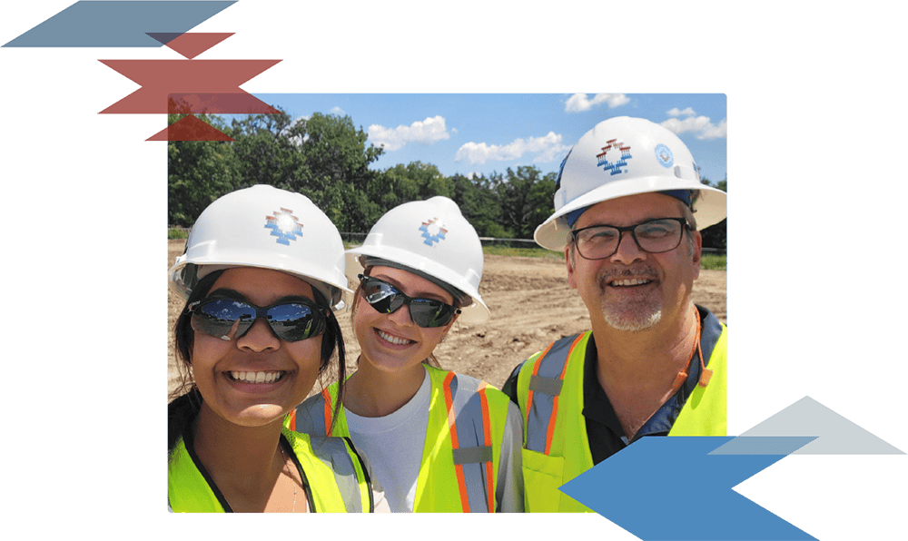 three tepa employees smiling in photo with hard hats on in the field